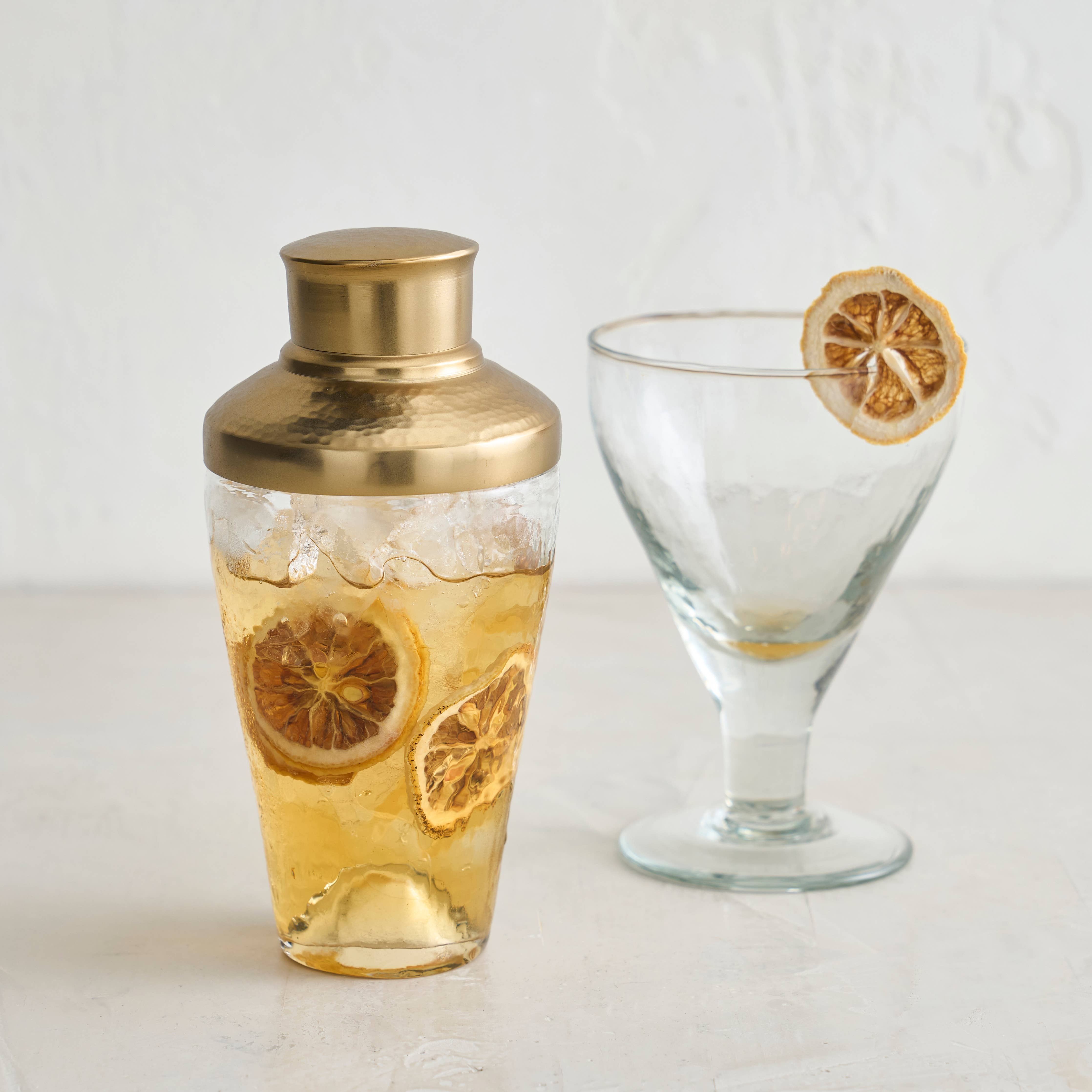 Shake up your drinks in style with the Pebbled Mini Shaker! This quirky glass shaker features brass accents for a touch of playful elegance. Perfect for mixing your favorite cocktails, it's the mini version of a classic bar essential. Cheers!
3" x 3" x 6.25"