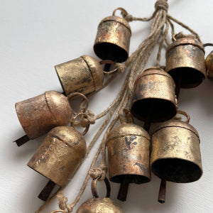 Add some festive charm to your home with these beautiful brass bells! Perfect for holiday decor, they come clustered with jute for a charming touch. Use them to add a touch of whimsy to your wreaths, doorways, mantels, and even countertops. Bring the holiday spirit into every corner of your home with these charming brass bells. As each bell/hanging is handmade, no two are exactly the same and small variations is to be expected in both size and finish.