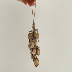 Add some festive charm to your home with these beautiful brass bells! Perfect for holiday decor, they come clustered with jute for a charming touch. Use them to add a touch of whimsy to your wreaths, doorways, mantels, and even countertops. Bring the holiday spirit into every corner of your home with these charming brass bells. As each bell/hanging is handmade, no two are exactly the same and small variations is to be expected in both size and finish.