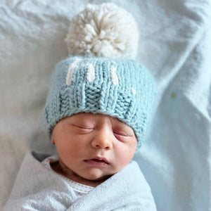 Introducing the Why Hi There Beanie - the cutest addition to any newborn's wardrobe! This blue hand knit baby beanie is complete with an adorable pom on top and is size 0-6 months. Say hello to the perfect gift for expecting parents or a precious addition to your own baby's collection. James 1:17
