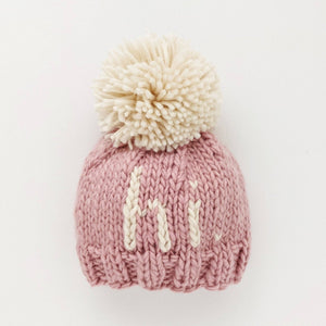 Add a playful pop of color to your little one's wardrobe with our Why Hi There Blush Beanie! Crafted with love and a cute pom on top, this hand knit beanie is the perfect gift for expecting parents or a sweet addition to your own baby's collection. Available in size 0-6 months. James 1:17