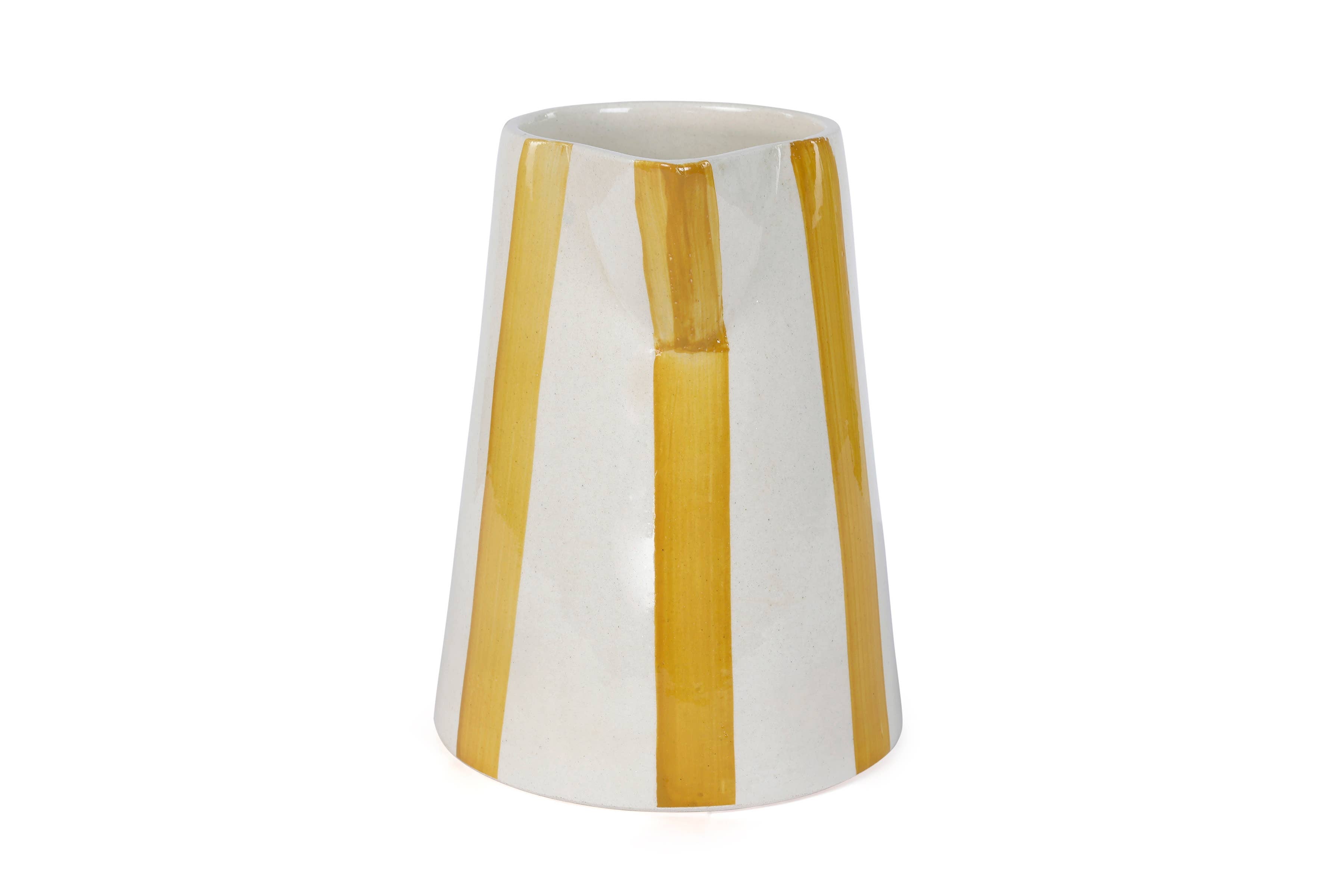 Elevate your home with this stylish and sturdy ceramic pitcher. Handcrafted with care, its playful stripes bring a touch of fun to your summer gatherings.

8.25 x 8.25 x 8
microwave and dishwasher safe
handpainted stoneware ceramic
artisan made
