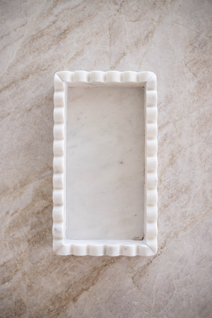 Enhance your bathroom or kitchen counters with the White Marble Scalloped Tray. Made with high-quality marble, this tray adds a soft and delicate touch to your space with its scalloped edge. Bring a refined and luxurious feel to your home with this versatile white tray, perfect for any room in your home.

9x5x1.5
handwash
made in India
