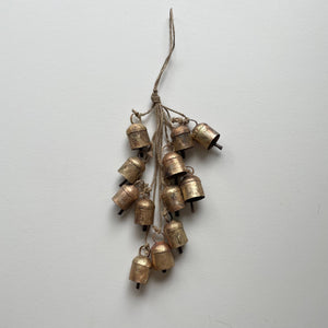 Add some festive charm to your home with these beautiful brass bells! Perfect for holiday decor, they come clustered with jute for a charming touch. Use them to add a touch of whimsy to your wreaths, doorways, mantels, and even countertops. Bring the holiday spirit into every corner of your home with these charming brass bells. As each bell/hanging is handmade, no two are exactly the same and small variations is to be expected in both size and finish.