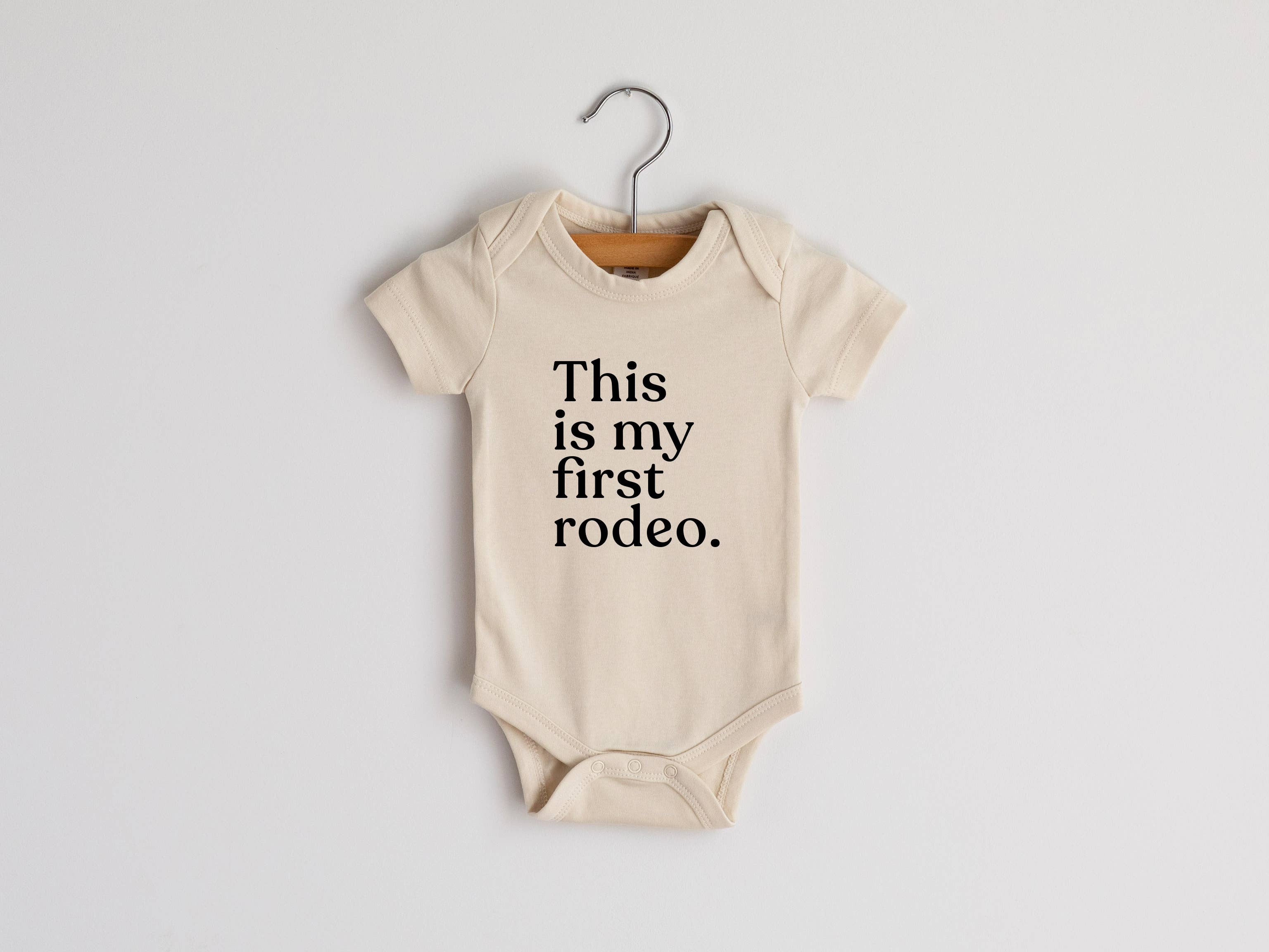 “This Is My First Rodeo” Organic Cotton Baby Onesie – Small Boots, Big Debut